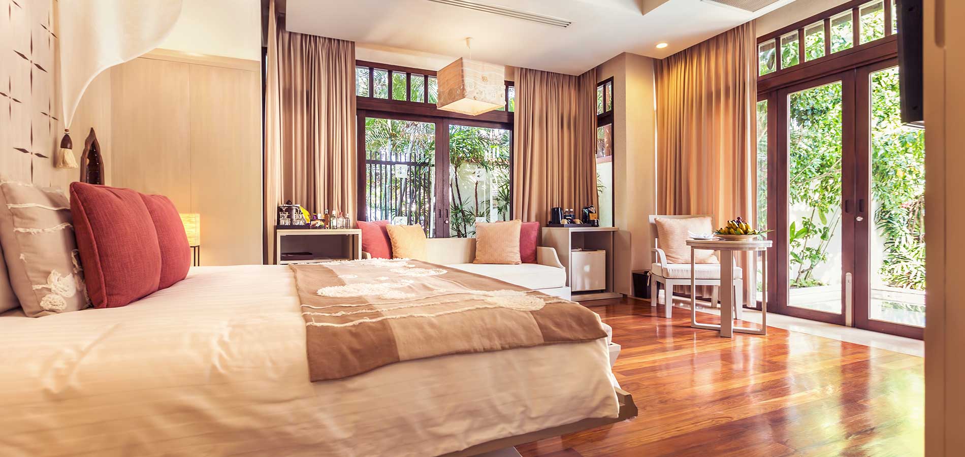 A bedroom with wooden floors and a large bed.